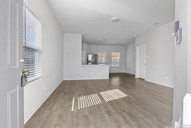 unfurnished living room with wood-type flooring