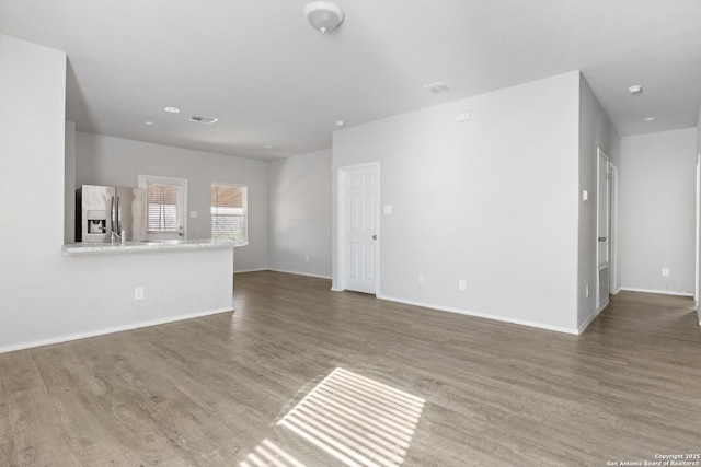 unfurnished living room featuring hardwood / wood-style flooring