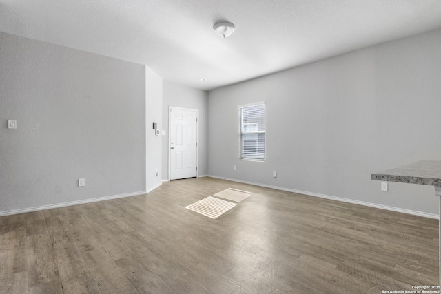 unfurnished room featuring hardwood / wood-style floors