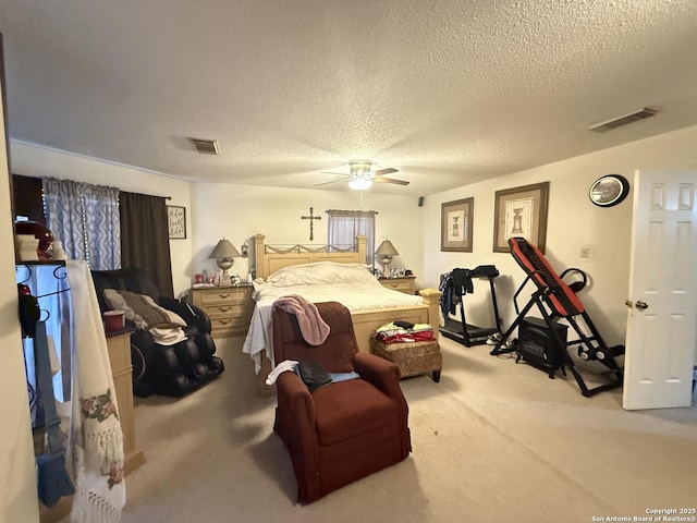 carpeted bedroom featuring a textured ceiling and ceiling fan