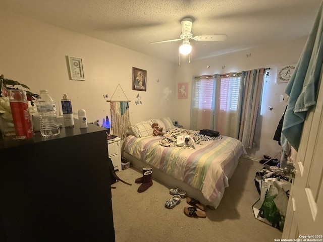 bedroom with carpet flooring, ceiling fan, and a textured ceiling