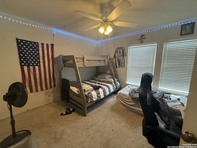 carpeted bedroom featuring a textured ceiling and ceiling fan