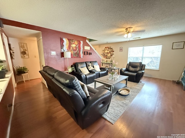 living room with wood-type flooring, a textured ceiling, and ceiling fan