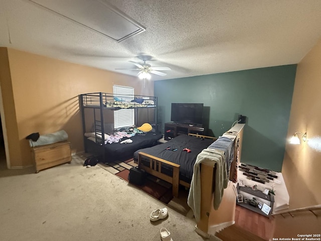 carpeted bedroom featuring ceiling fan and a textured ceiling