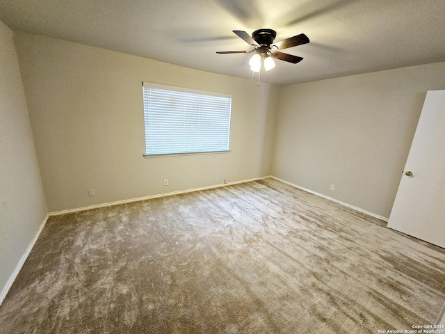 unfurnished room with ceiling fan and carpet floors