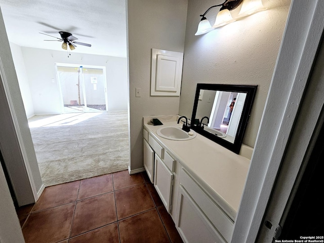 bathroom with tile patterned flooring, vanity, and ceiling fan