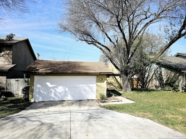 view of side of home with a lawn and a garage