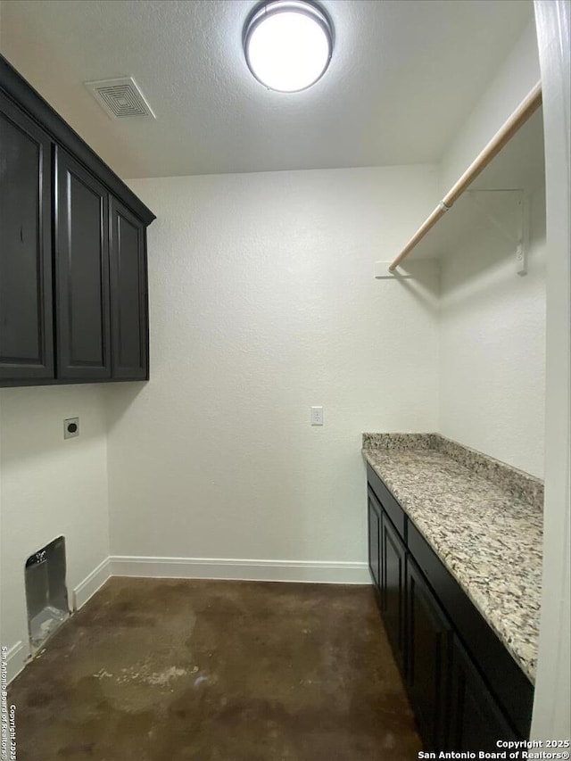 laundry area with cabinets and hookup for an electric dryer