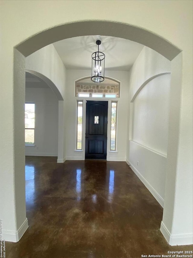 foyer with plenty of natural light and a chandelier