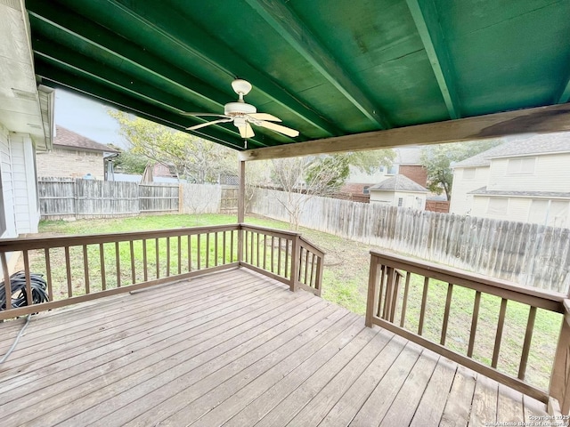 wooden deck featuring ceiling fan and a yard