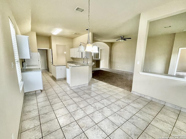 kitchen featuring ceiling fan, sink, pendant lighting, light tile patterned floors, and white cabinets