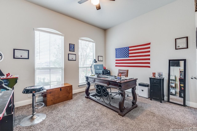 office space featuring carpet flooring, ceiling fan, and a healthy amount of sunlight