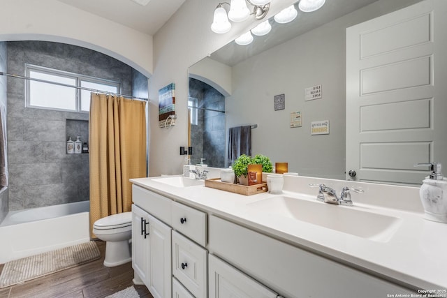 full bathroom featuring vanity, toilet, wood-type flooring, and shower / tub combo with curtain