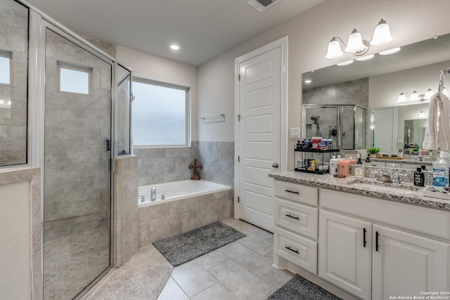 bathroom with separate shower and tub, tile patterned flooring, and vanity