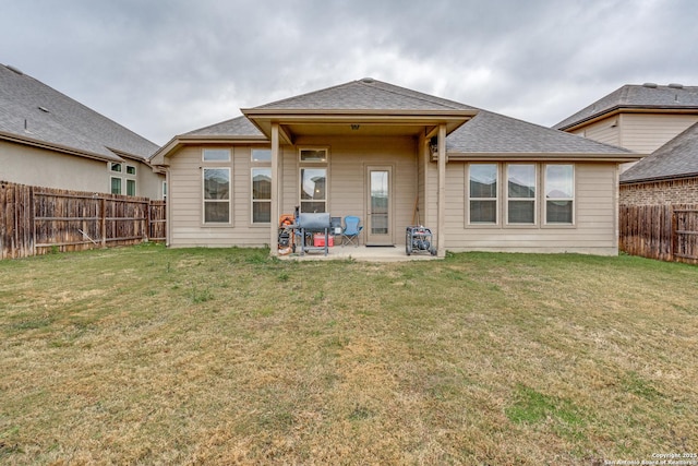 back of property featuring a lawn and a patio area