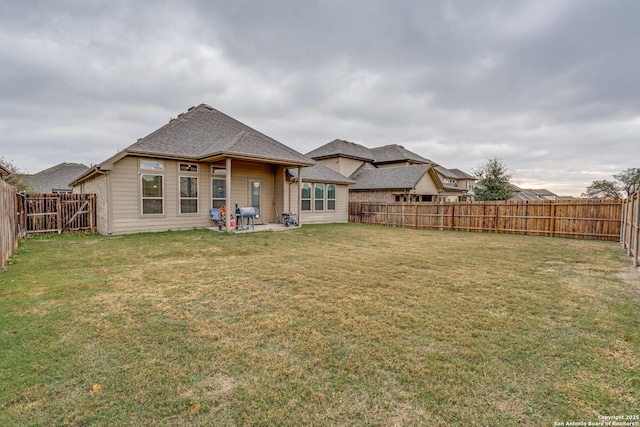 back of property featuring a yard and a patio