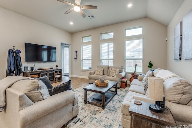 living room featuring ceiling fan, light hardwood / wood-style floors, and lofted ceiling