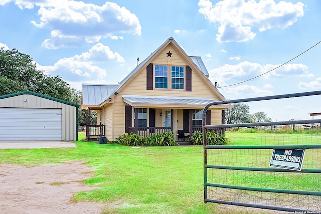 view of front of home featuring an outdoor structure, a front lawn, a porch, and a garage