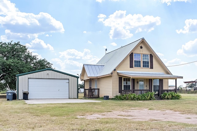 view of front of home featuring an outbuilding, a porch, a garage, and a front yard