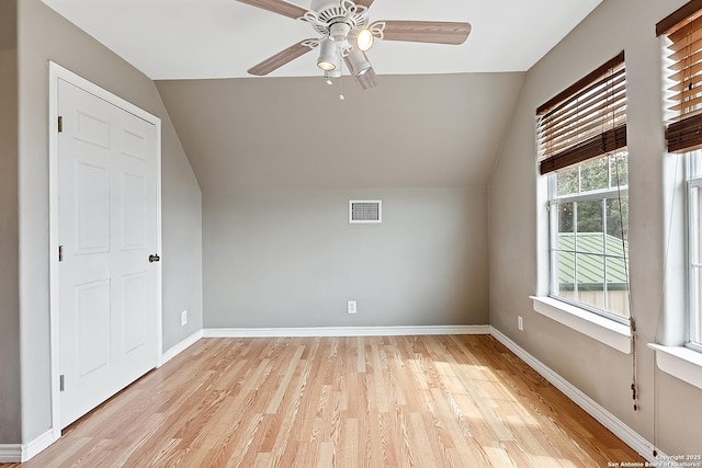 bonus room with ceiling fan, light hardwood / wood-style flooring, and vaulted ceiling