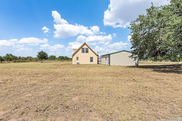 exterior space with a rural view and an outbuilding