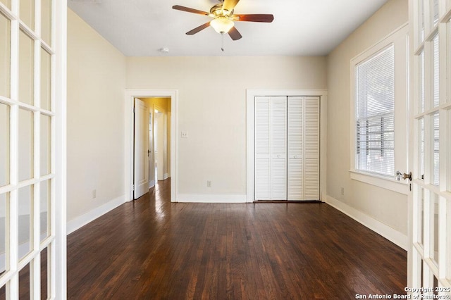 unfurnished bedroom featuring dark hardwood / wood-style floors, a closet, ceiling fan, and french doors