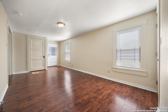 empty room featuring dark hardwood / wood-style floors