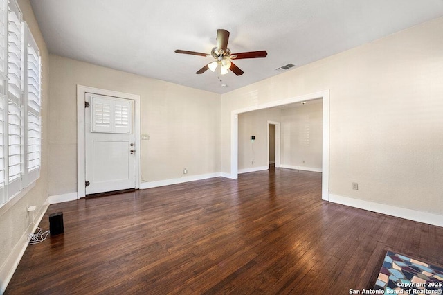 unfurnished room with ceiling fan and dark hardwood / wood-style flooring