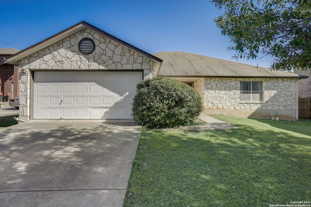 ranch-style home with a garage and a front yard