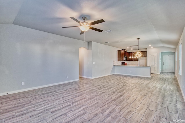 unfurnished living room with light hardwood / wood-style flooring, ceiling fan, and lofted ceiling