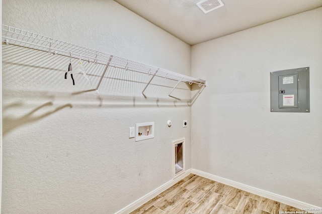 washroom featuring electric dryer hookup, electric panel, hookup for a gas dryer, and washer hookup