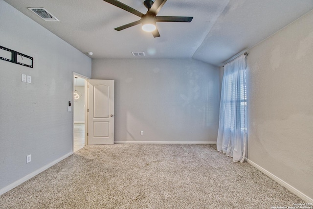 carpeted empty room with a textured ceiling, ceiling fan, and lofted ceiling