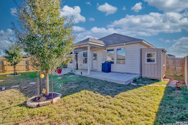 back of property with a patio and a lawn