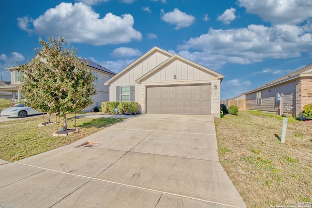 view of front of property with a garage and a front lawn