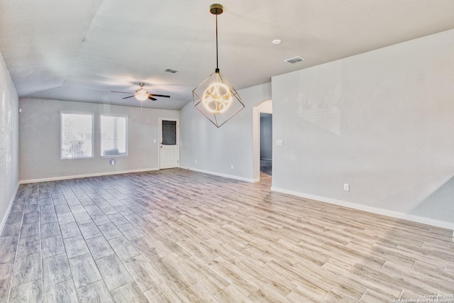 unfurnished room with ceiling fan, vaulted ceiling, and light hardwood / wood-style flooring