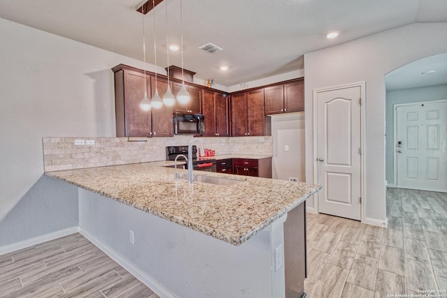 kitchen with black appliances, decorative light fixtures, kitchen peninsula, and sink