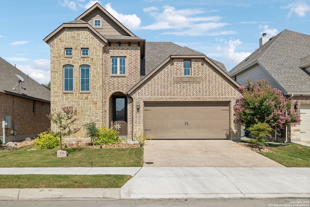 view of front of house featuring a front lawn and a garage