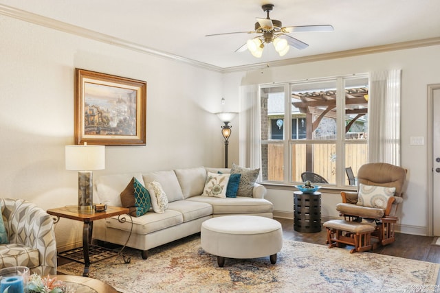 living room with ceiling fan, ornamental molding, and dark wood-type flooring