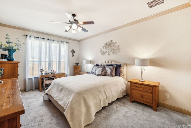 carpeted bedroom with ceiling fan and crown molding