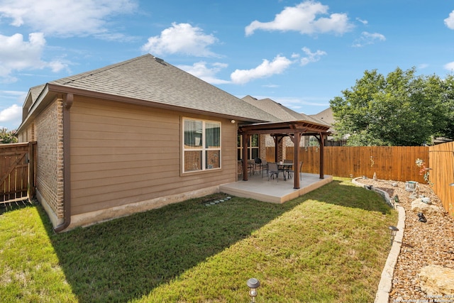 back of property featuring a gazebo, a yard, and a patio