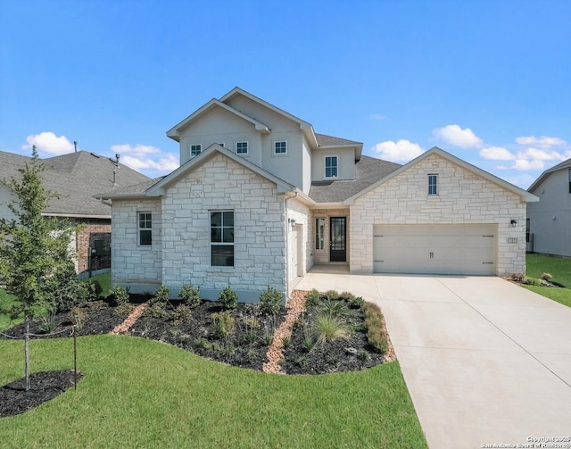 view of front of house with a front yard and a garage