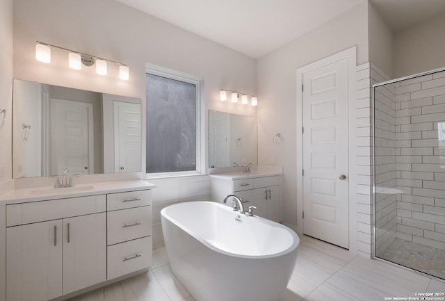 bathroom with vanity and independent shower and bath