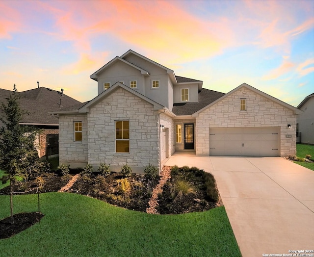 view of front of property featuring a yard and a garage