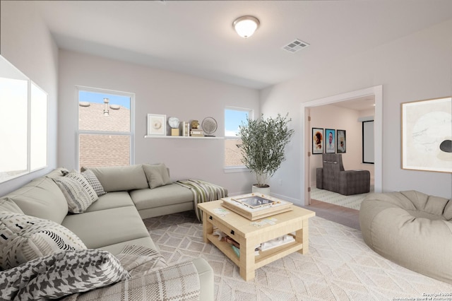 carpeted living room featuring plenty of natural light