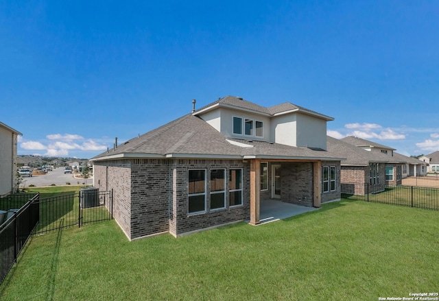 rear view of property featuring a patio area and a lawn