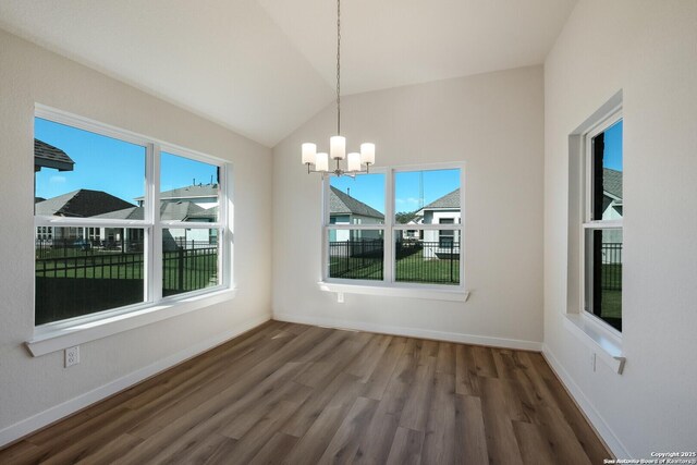 unfurnished dining area featuring a chandelier, vaulted ceiling, and dark wood-type flooring