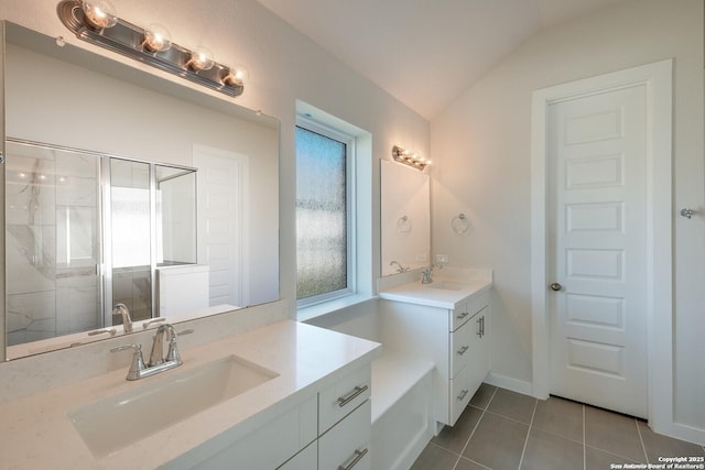 bathroom with tile patterned flooring, vanity, lofted ceiling, and walk in shower