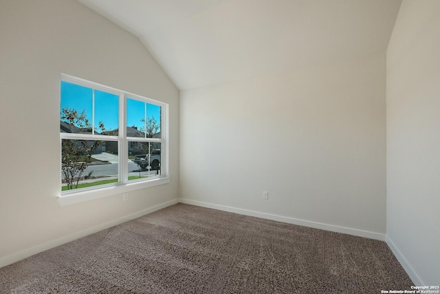 unfurnished room featuring carpet floors and vaulted ceiling