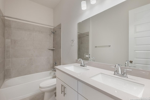 full bathroom featuring tiled shower / bath combo, toilet, and vanity