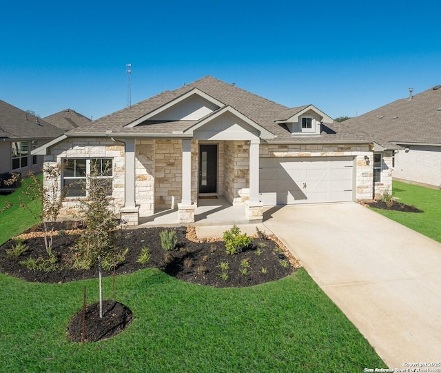 view of front of house featuring a front yard and a garage